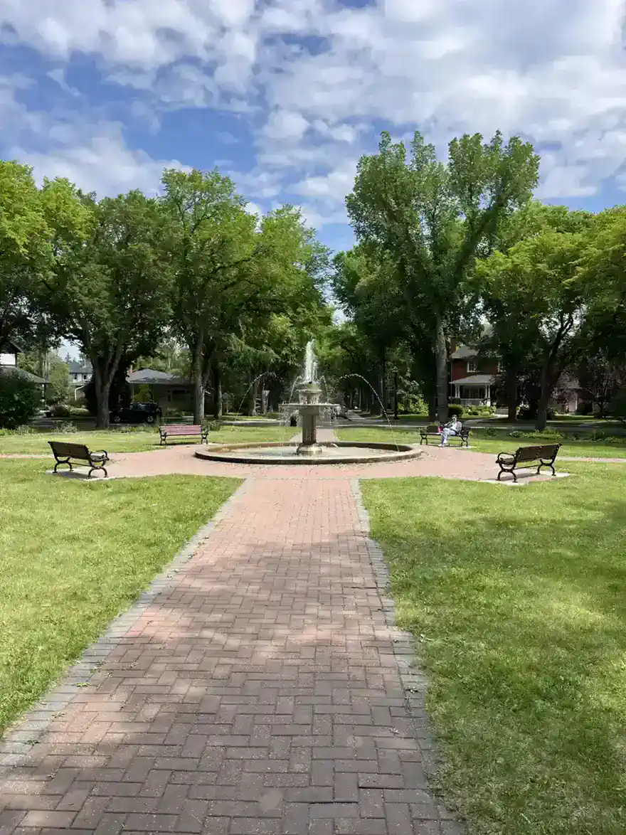 Alexander Circle fountain ringed by mature trees in Glenora, west-central Edmonton