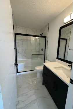 Client photo of a clean glass shower and vanity after a Mill Woods move-out clean