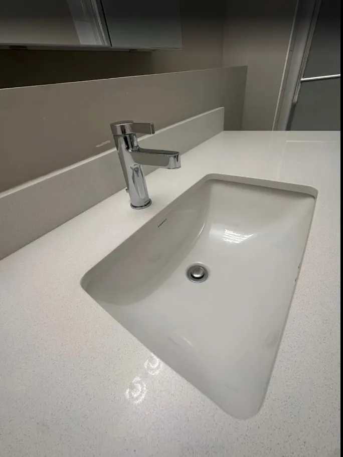 Undermount sink and faucet descaled and polished during move-out cleaning, client photo