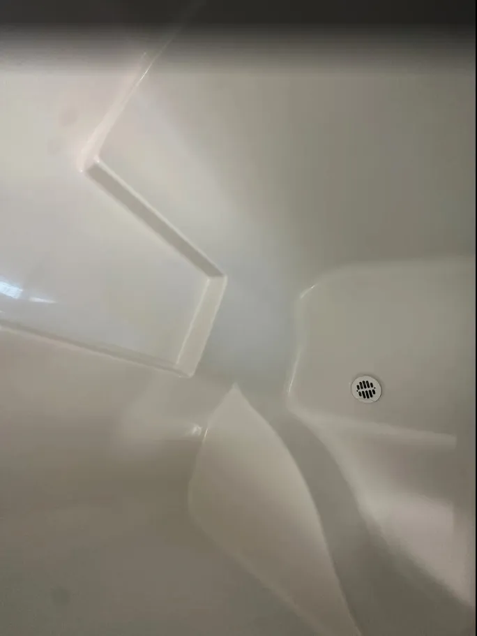 Shower pan cleaned free of soap scum during an Edmonton move-out cleaning, client photo